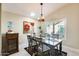 Inviting dining room with a skylight, chandelier, and a dark wood table at 14385 W Morning Star Trl, Surprise, AZ 85374