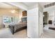 Spacious main bedroom featuring a vaulted ceiling, decorative ceiling fan, and comfortable sitting area at 14385 W Morning Star Trl, Surprise, AZ 85374