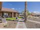 Backyard featuring a covered patio, artificial turf, and desert landscaping at 1440 W Christie Lyn Ln, San Tan Valley, AZ 85144