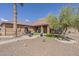 Backyard with desert landscaping, artificial turf, fountain, and covered patio at 1440 W Christie Lyn Ln, San Tan Valley, AZ 85144