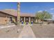 Backyard with desert landscaping, artificial turf, fountain, and covered patio at 1440 W Christie Lyn Ln, San Tan Valley, AZ 85144