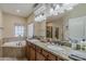 Bright bathroom featuring a soaking tub and granite countertop with double sinks at 1440 W Christie Lyn Ln, San Tan Valley, AZ 85144