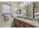 Bathroom featuring granite countertop with double sinks, vanity, and towel rack at 1440 W Christie Lyn Ln, San Tan Valley, AZ 85144