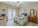 Bright bedroom with ceiling fan and french doors with a dog laying on the bed at 1440 W Christie Lyn Ln, San Tan Valley, AZ 85144