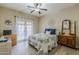 Bright bedroom with ceiling fan and french doors with a dog laying on the bed at 1440 W Christie Lyn Ln, San Tan Valley, AZ 85144