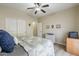 This bedroom features a ceiling fan, dresser and a wall full of decorative wall art at 1440 W Christie Lyn Ln, San Tan Valley, AZ 85144