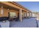 The covered patio area offers a relaxed outdoor dining and entertaining space with a grill and desert views at 1440 W Christie Lyn Ln, San Tan Valley, AZ 85144