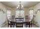 Bright dining room featuring a chandelier and desert views from the large windows at 1440 W Christie Lyn Ln, San Tan Valley, AZ 85144