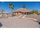 Single-story home with desert landscaping, stairs to the front door, and palm trees at 1440 W Christie Lyn Ln, San Tan Valley, AZ 85144