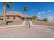 Single-story home with desert landscaping, stairs to the front door, and palm trees at 1440 W Christie Lyn Ln, San Tan Valley, AZ 85144