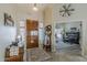 Welcoming foyer featuring a wooden door, tiled floor, and views to living spaces at 1440 W Christie Lyn Ln, San Tan Valley, AZ 85144