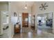 Welcoming foyer featuring a wooden door, tiled floor, and views to living spaces at 1440 W Christie Lyn Ln, San Tan Valley, AZ 85144