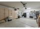 A well-organized garage with a refrigerator, cabinets, water heater, a barrel, and ample space for storage at 1440 W Christie Lyn Ln, San Tan Valley, AZ 85144