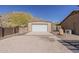 A separate garage structure offering ample storage and parking space, complemented by the surrounding desert landscape at 1440 W Christie Lyn Ln, San Tan Valley, AZ 85144