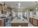 Kitchen with island, stainless steel appliances, and dining table with bright window views at 1440 W Christie Lyn Ln, San Tan Valley, AZ 85144