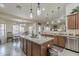 Open kitchen and dining area with a large island, granite counters, and stainless steel appliances at 1440 W Christie Lyn Ln, San Tan Valley, AZ 85144