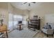 Bright living room featuring a piano, sitting area, and large window letting in natural light at 1440 W Christie Lyn Ln, San Tan Valley, AZ 85144