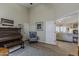 Living room showcasing a piano and a sitting chair with access to other living spaces at 1440 W Christie Lyn Ln, San Tan Valley, AZ 85144