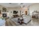 Open-concept living room with fireplace, vaulted ceiling, and a charming wooden door at 1440 W Christie Lyn Ln, San Tan Valley, AZ 85144