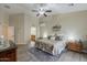 Neutral toned main bedroom with plank flooring, ceiling fan and decorative furnishings at 1440 W Christie Lyn Ln, San Tan Valley, AZ 85144