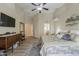 Light main bedroom with decorative furnishings, a ceiling fan, and ensuite bathroom at 1440 W Christie Lyn Ln, San Tan Valley, AZ 85144