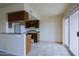 Bright kitchen with tile flooring, wood cabinets, and a sliding glass door to the outside at 14620 N Yerba Buena Way # D, Fountain Hills, AZ 85268