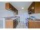 Galley-style kitchen featuring sleek wood cabinets, laminate countertops, and a white appliance package at 14620 N Yerba Buena Way # D, Fountain Hills, AZ 85268