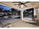 Inviting back patio featuring a ceiling fan, outdoor furniture, and a view of the pool at 15273 N 92Nd Pl, Scottsdale, AZ 85260