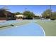 Community basketball court featuring vibrant blue and green surfaces, surrounded by mature trees and shaded areas at 15273 N 92Nd Pl, Scottsdale, AZ 85260