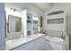 Bright bathroom featuring double sinks, marble countertops, modern fixtures, and separate tub at 15273 N 92Nd Pl, Scottsdale, AZ 85260