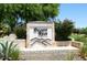 Elegant Desert Rose community sign surrounded by vibrant landscaping and manicured greenery at 15273 N 92Nd Pl, Scottsdale, AZ 85260