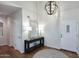 Inviting entryway with tall ceilings, decorative lighting, a stylish console table, and a round rug at 15273 N 92Nd Pl, Scottsdale, AZ 85260