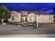 Charming single-Gathering home with desert landscaping, neutral paint, and a red tile roof, illuminated at dusk at 15273 N 92Nd Pl, Scottsdale, AZ 85260