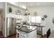 Bright kitchen with stainless appliances, black countertops, and white cabinetry at 15273 N 92Nd Pl, Scottsdale, AZ 85260