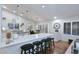 Modern kitchen with white cabinets, a kitchen island, bar stool seating, and recessed lighting at 15273 N 92Nd Pl, Scottsdale, AZ 85260