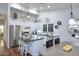 Bright kitchen with stainless steel appliances, granite countertops, island with seating, and modern fixtures at 15273 N 92Nd Pl, Scottsdale, AZ 85260