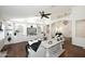 Beautiful living room with vaulted ceiling, a ceiling fan, built-in cabinetry, and hardwood flooring at 15273 N 92Nd Pl, Scottsdale, AZ 85260