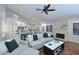 Open living space with hardwood flooring, a fireplace, neutral colored furnishings, and modern kitchen view at 15273 N 92Nd Pl, Scottsdale, AZ 85260