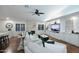 Cozy living room with a stone fireplace, plush seating, hardwood floors, and built-in shelving at 15273 N 92Nd Pl, Scottsdale, AZ 85260