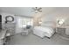 Calming bedroom with soft colors, plantation shutters, ceiling fan, and comfortable seating area at 15273 N 92Nd Pl, Scottsdale, AZ 85260