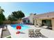 Inviting pool area with patio seating, sun loungers, and serene landscaping, perfect for entertaining at 15273 N 92Nd Pl, Scottsdale, AZ 85260