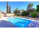 Relaxing pool area with lounge chairs, basketball hoop, and beautiful landscaping perfect for outdoor fun at 15273 N 92Nd Pl, Scottsdale, AZ 85260