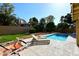 Private pool surrounded by lush landscaping with deck furniture, great for relaxing at 15273 N 92Nd Pl, Scottsdale, AZ 85260