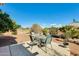 Spacious backyard featuring a seating area, lush landscaping, and a clear blue sky at 15840 W Falcon Ridge Dr, Sun City West, AZ 85375