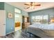 Well-lit bedroom shows ensuite bathroom, neutral walls, and decorative wooden dresser at 15840 W Falcon Ridge Dr, Sun City West, AZ 85375