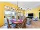 Sun-filled dining room with sliding door access to the backyard and seamless flow to the living space at 15840 W Falcon Ridge Dr, Sun City West, AZ 85375