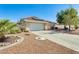 Charming single-story home featuring a spacious garage, desert landscaping, and a red tile roof at 15840 W Falcon Ridge Dr, Sun City West, AZ 85375