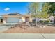 Inviting front exterior with well-maintained desert landscaping, tile roof, and a spacious two-car garage at 15840 W Falcon Ridge Dr, Sun City West, AZ 85375