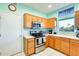 Bright kitchen featuring stainless steel appliances, oak cabinets and natural light at 15840 W Falcon Ridge Dr, Sun City West, AZ 85375