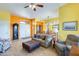 Inviting living area with bright, vibrant colors, tile flooring, and stylish decor at 15840 W Falcon Ridge Dr, Sun City West, AZ 85375